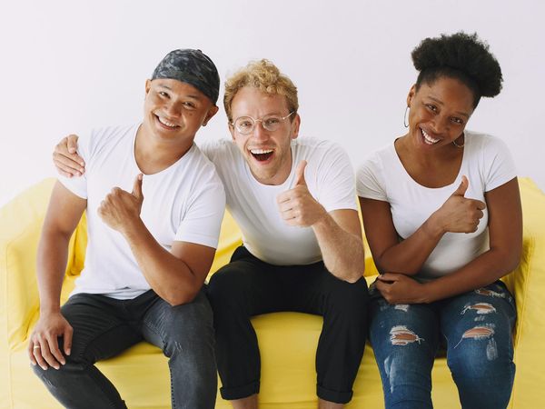 Diverse group of people smiling in a bright studio.